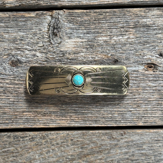 gold hair clip with a turquoise stone on a neutral background | rodeo drive conchos |