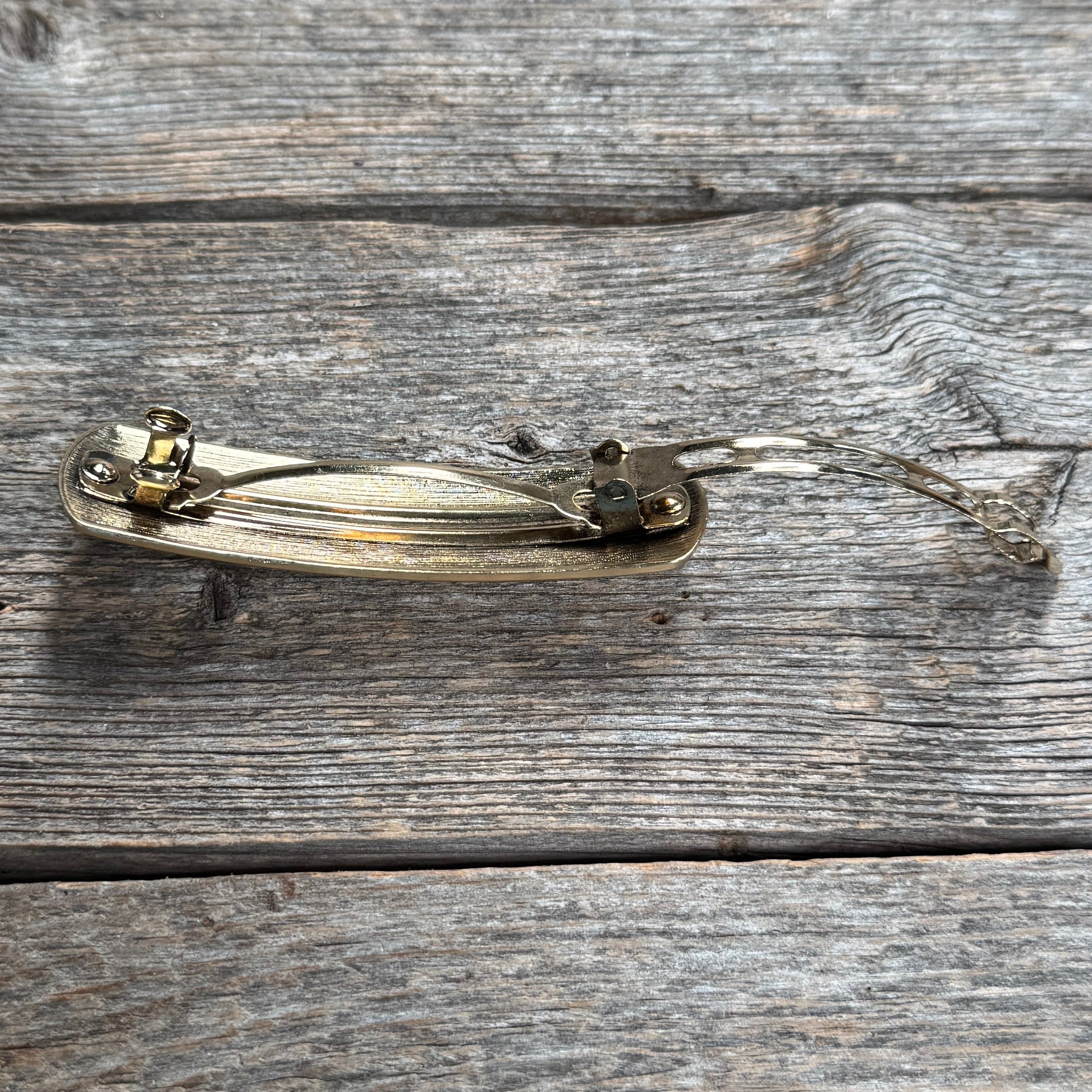  gold hair clip  accessory back with a turquoise stone on a neutral background | rodeo drive conchos |