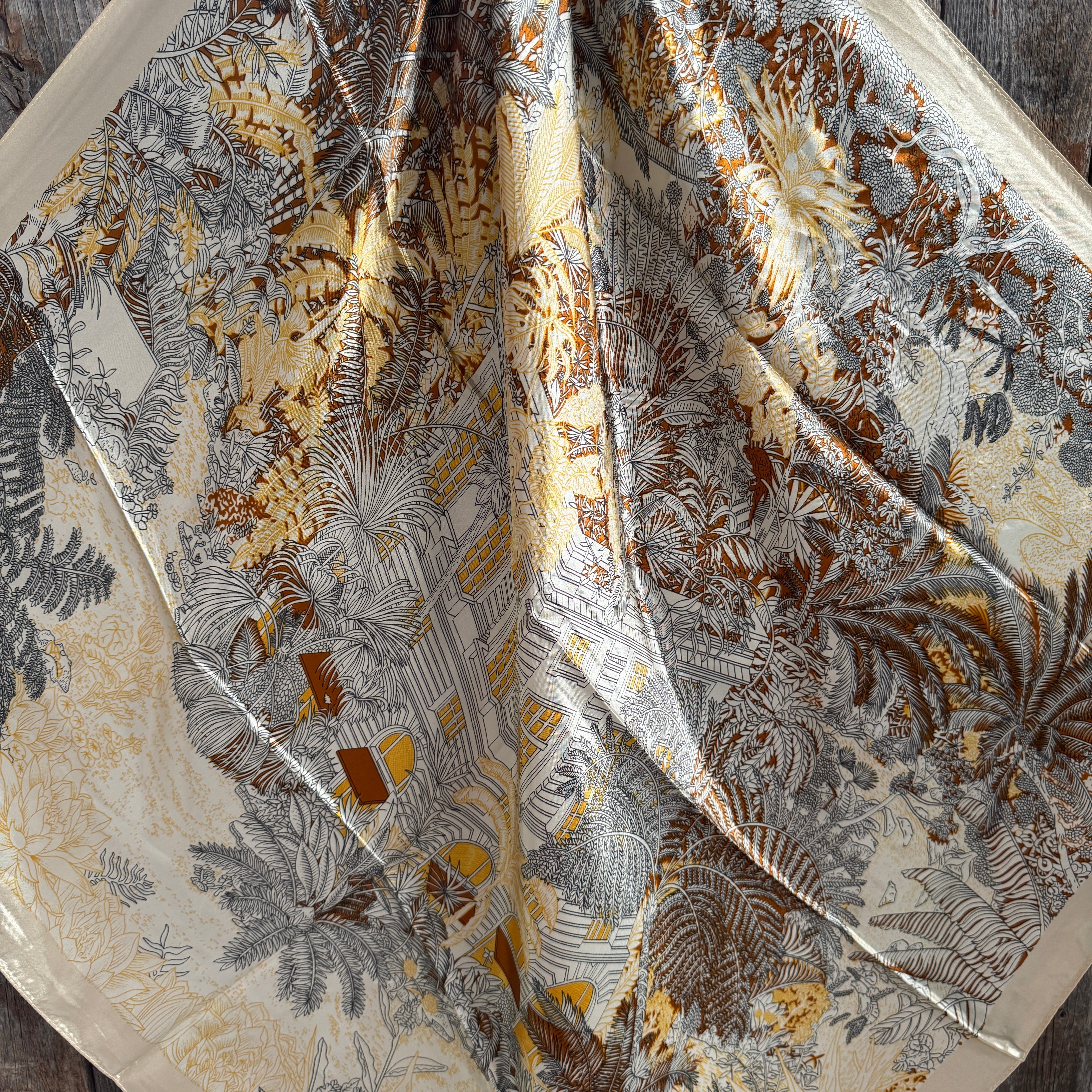 Close-up of a fabric with intricate floral pattern on a wooden surface