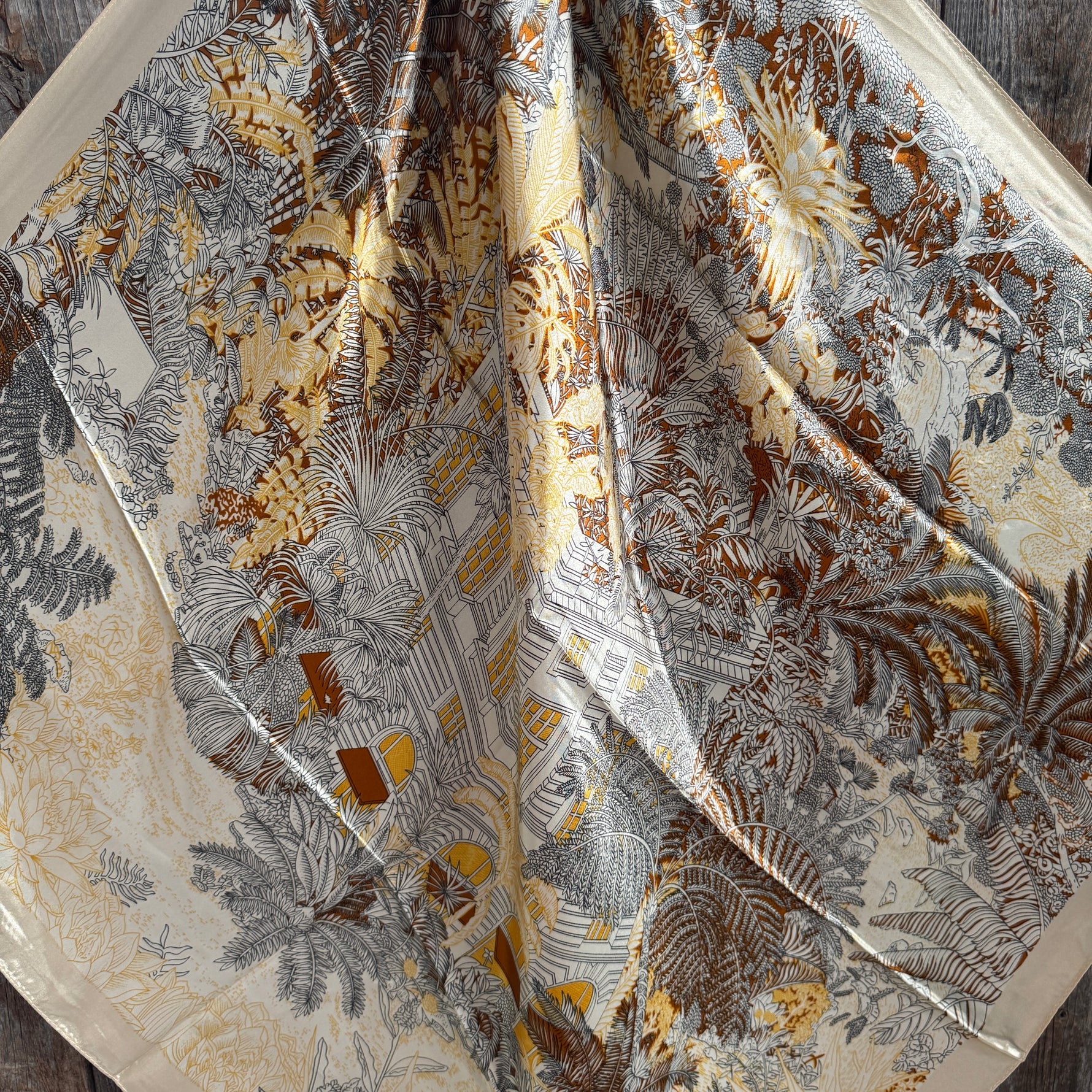 Close-up of a fabric with intricate floral pattern on a wooden surface