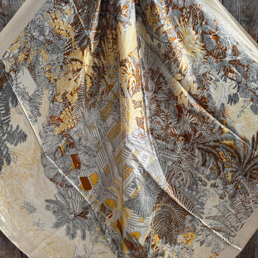 Close-up of a fabric with intricate floral pattern on a wooden surface