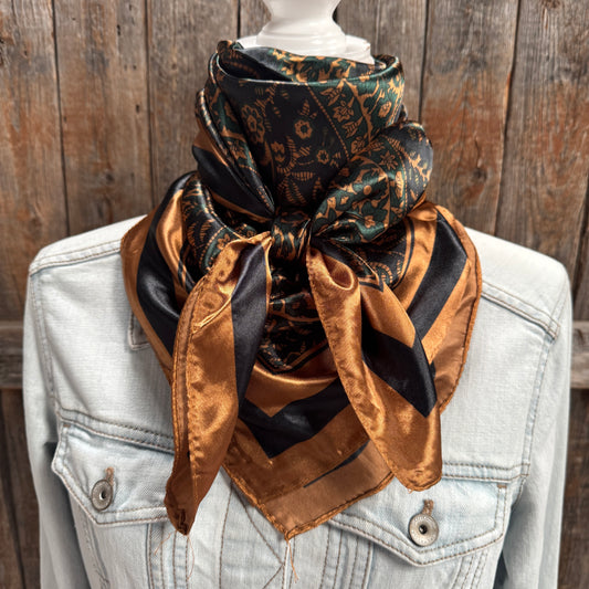 Mannequin wearing a patterned scarf with a wooden background
