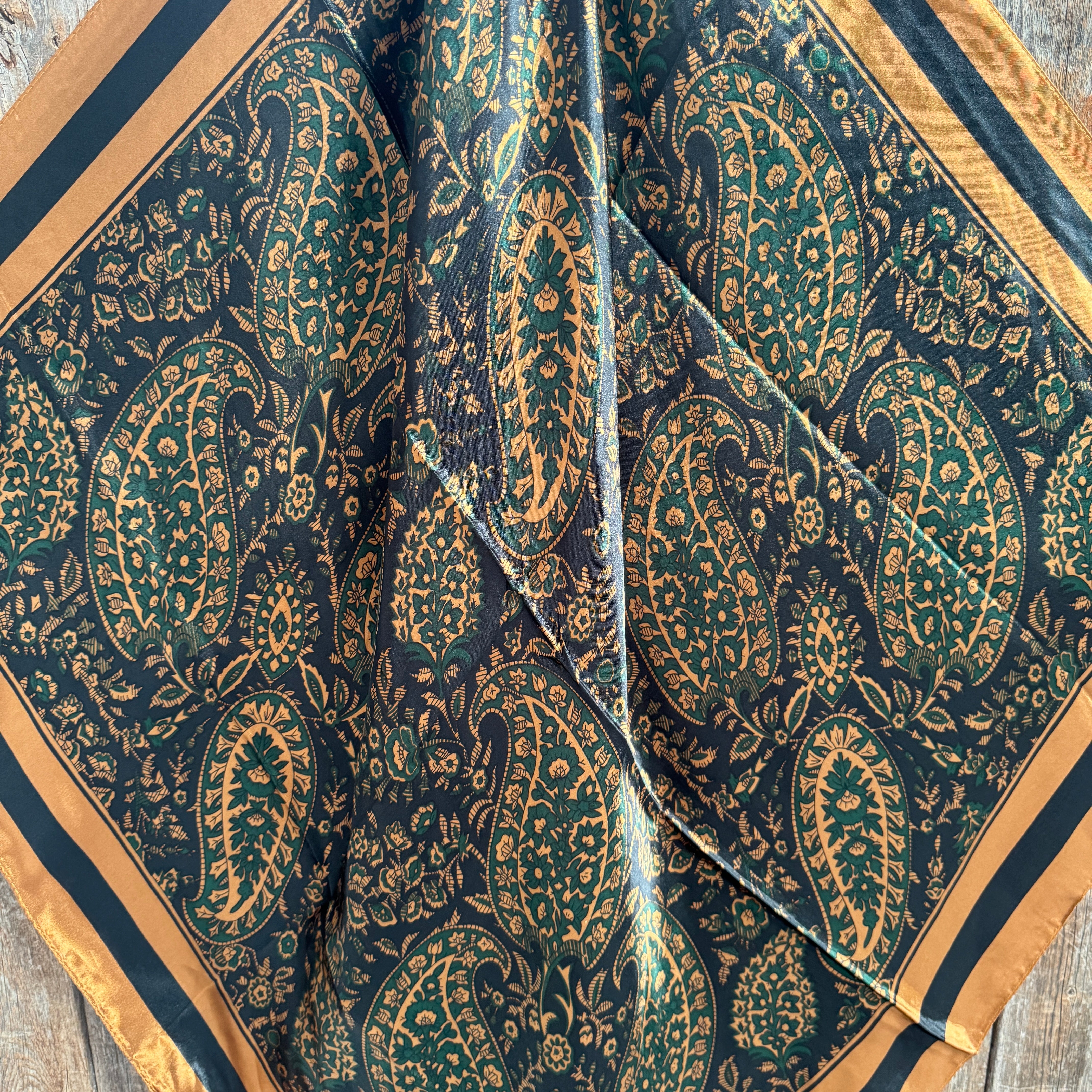Patterned fabric with paisley design on a wooden surface