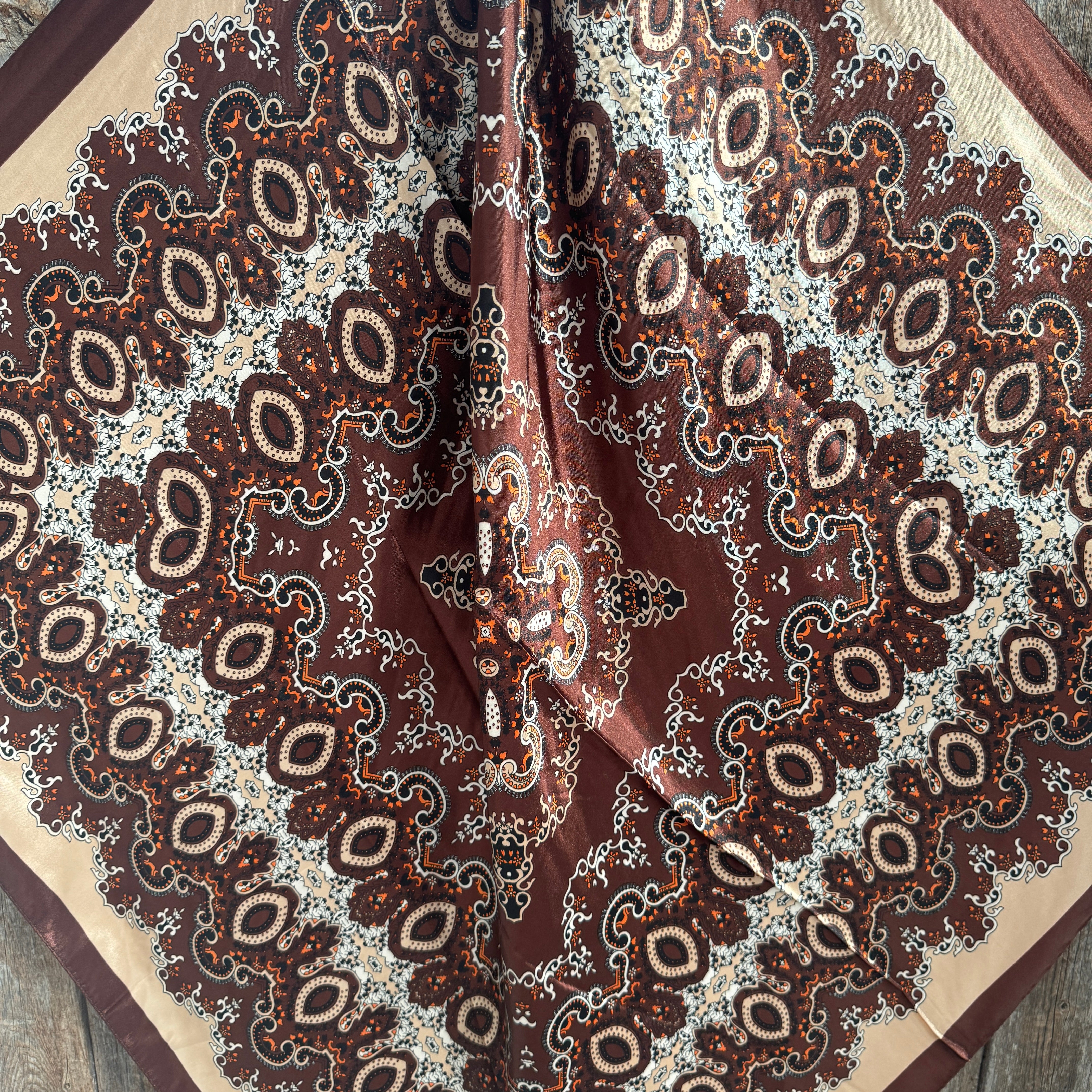 Close-up of a brown and beige patterned wild rag scarf