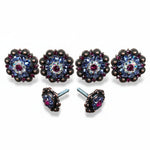 a pair of ornate, decorative knobs with a floral design and a central gemstone.
