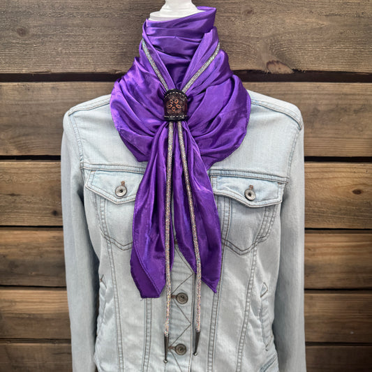 a purple scarf tied to a jacket on a mannequin