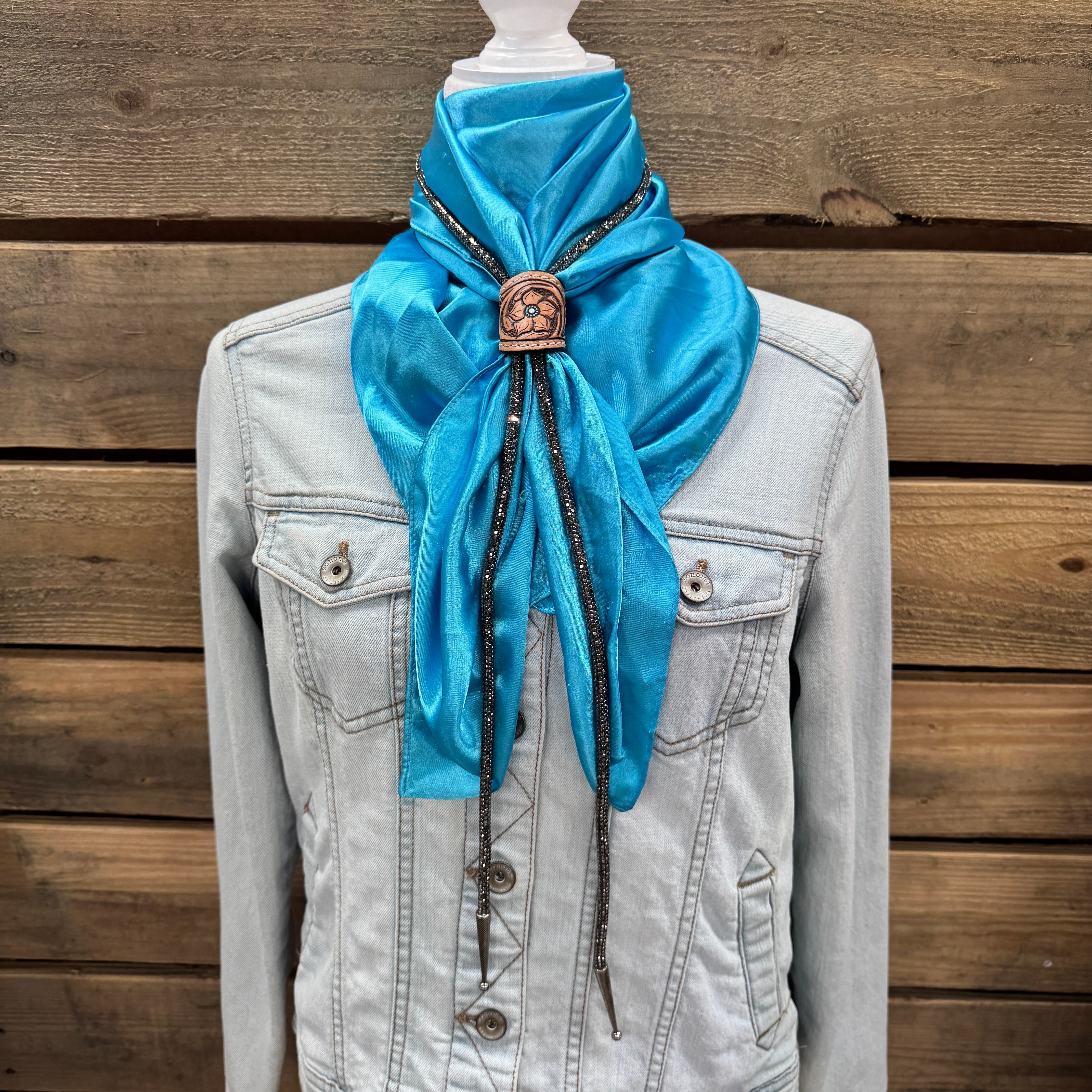 a blue scarf tied to a jacket on a mannequin
