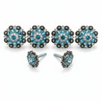 a pair of ornate earrings with blue gemstones and silver metalwork.