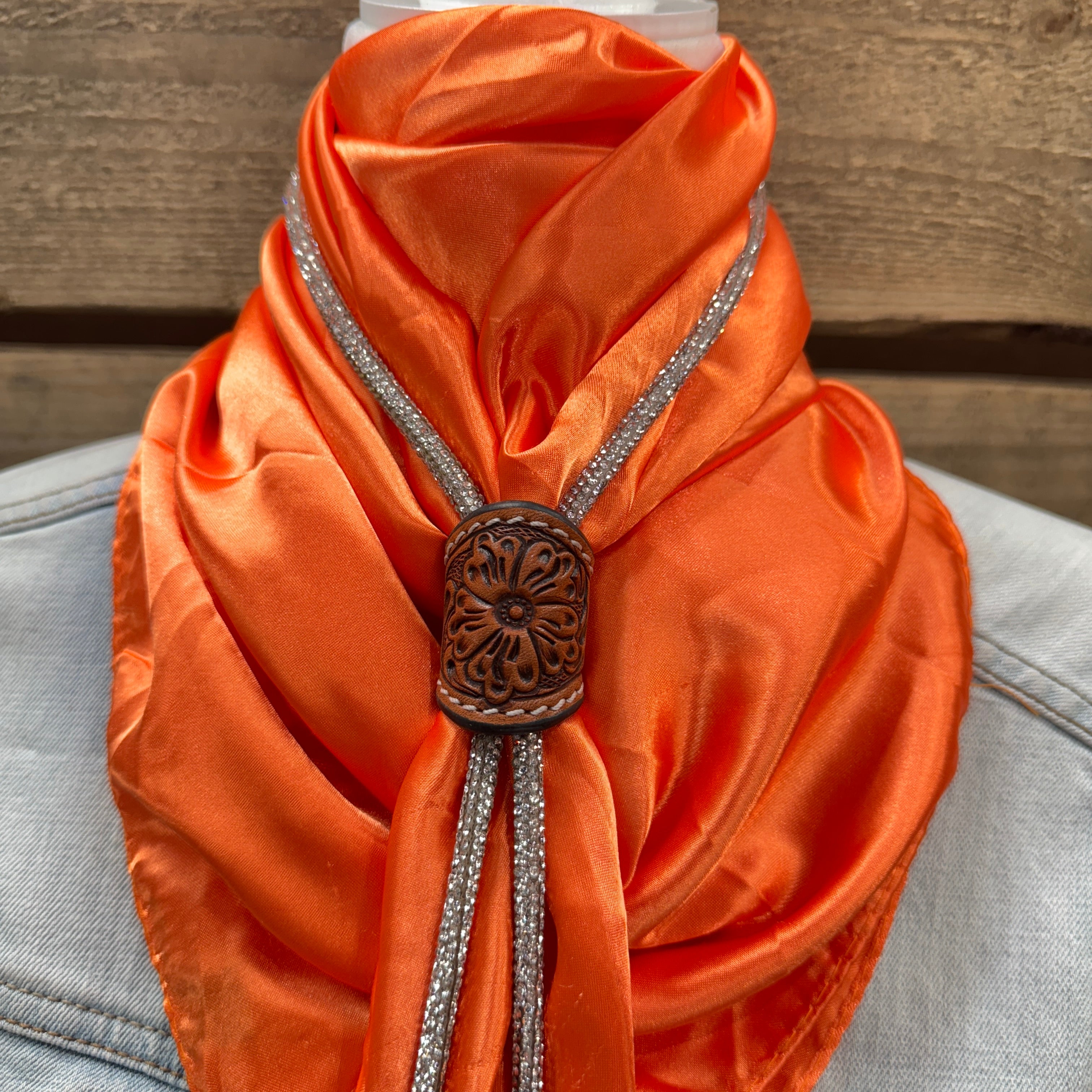 a close up of an orange scarf on a mannequin