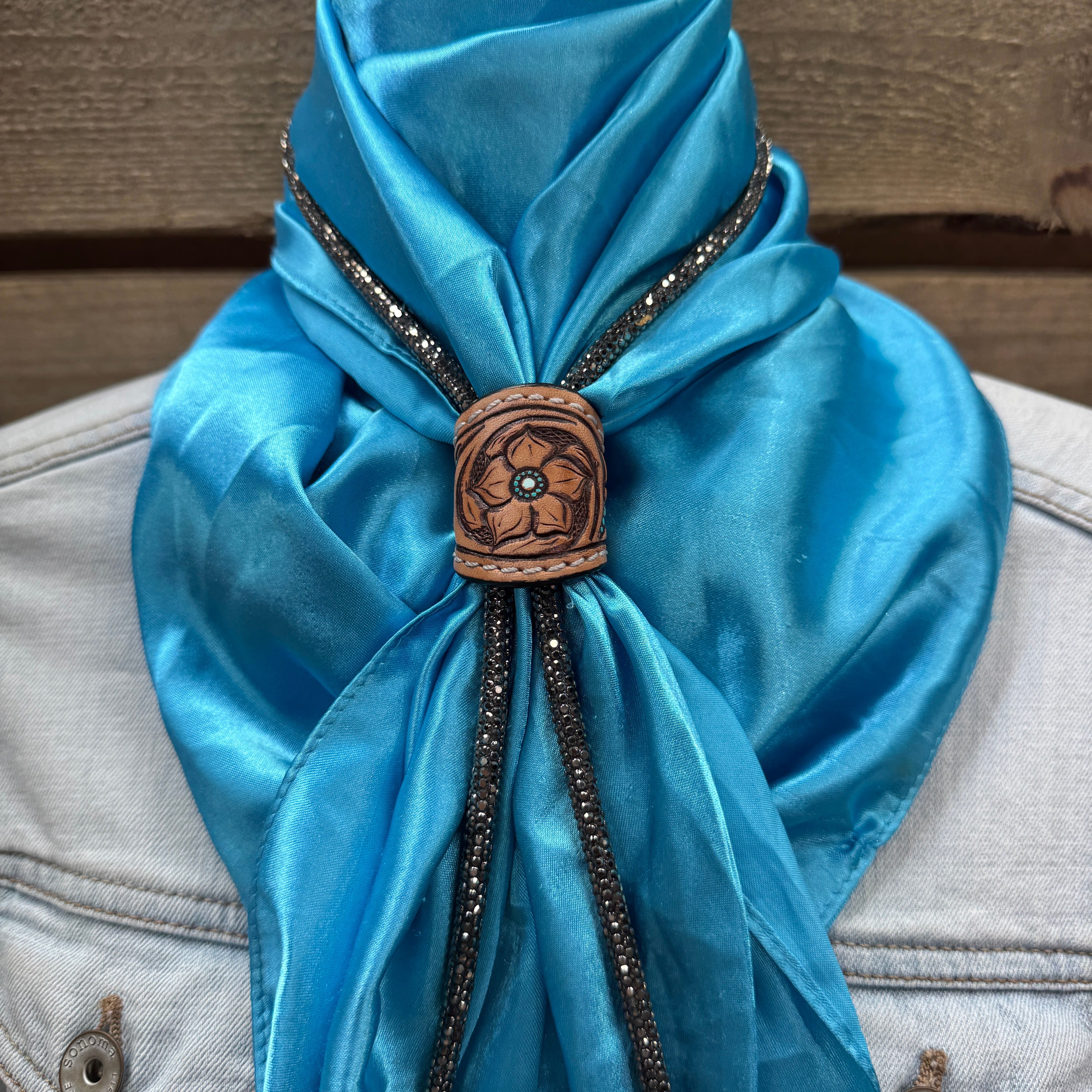 a blue scarf with a wooden button on it