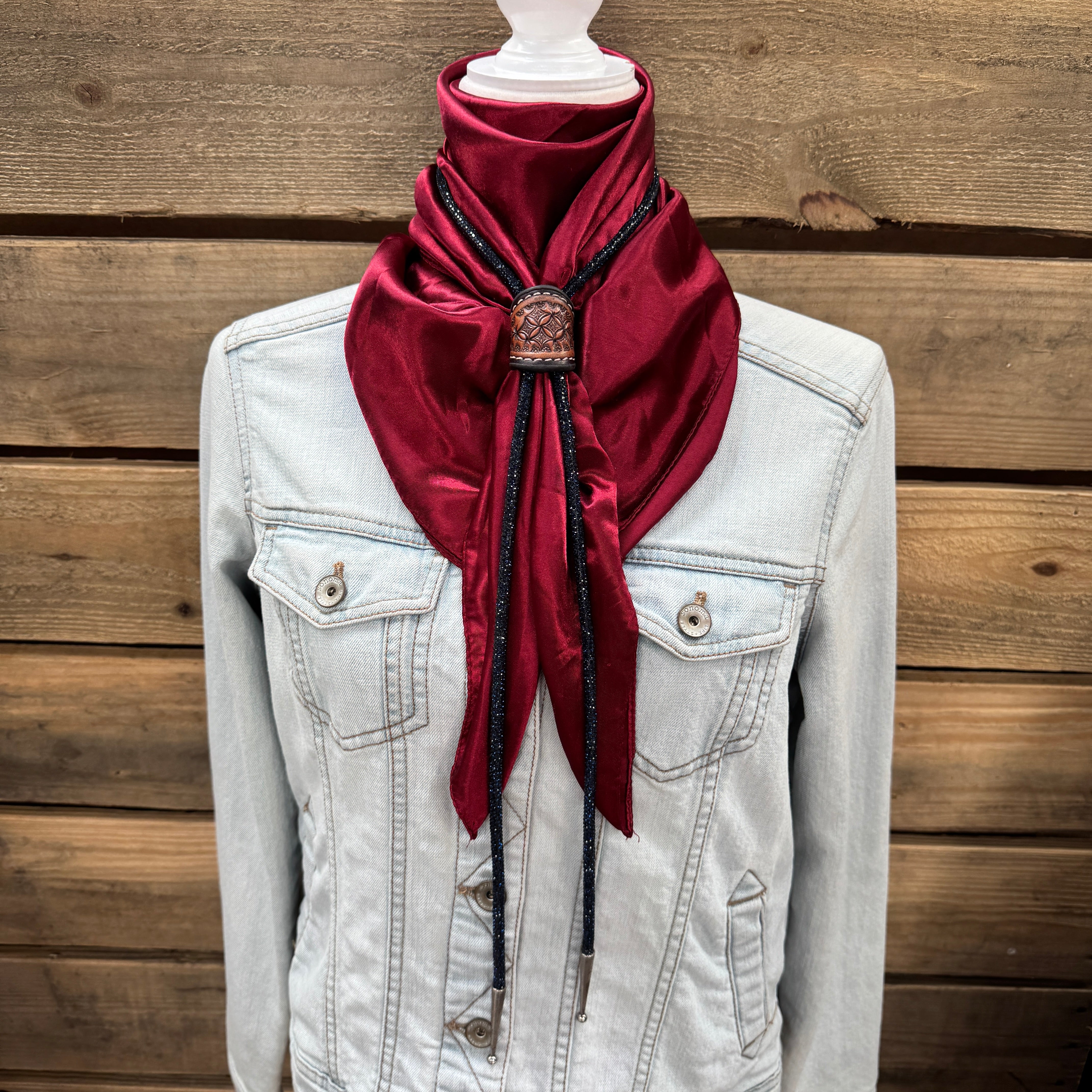 a white jacket and a red scarf on a mannequin