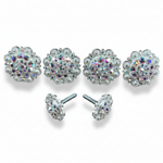 a collection of ornate, sparkling jewelry pieces, including earrings and buttons, arranged in a row.
