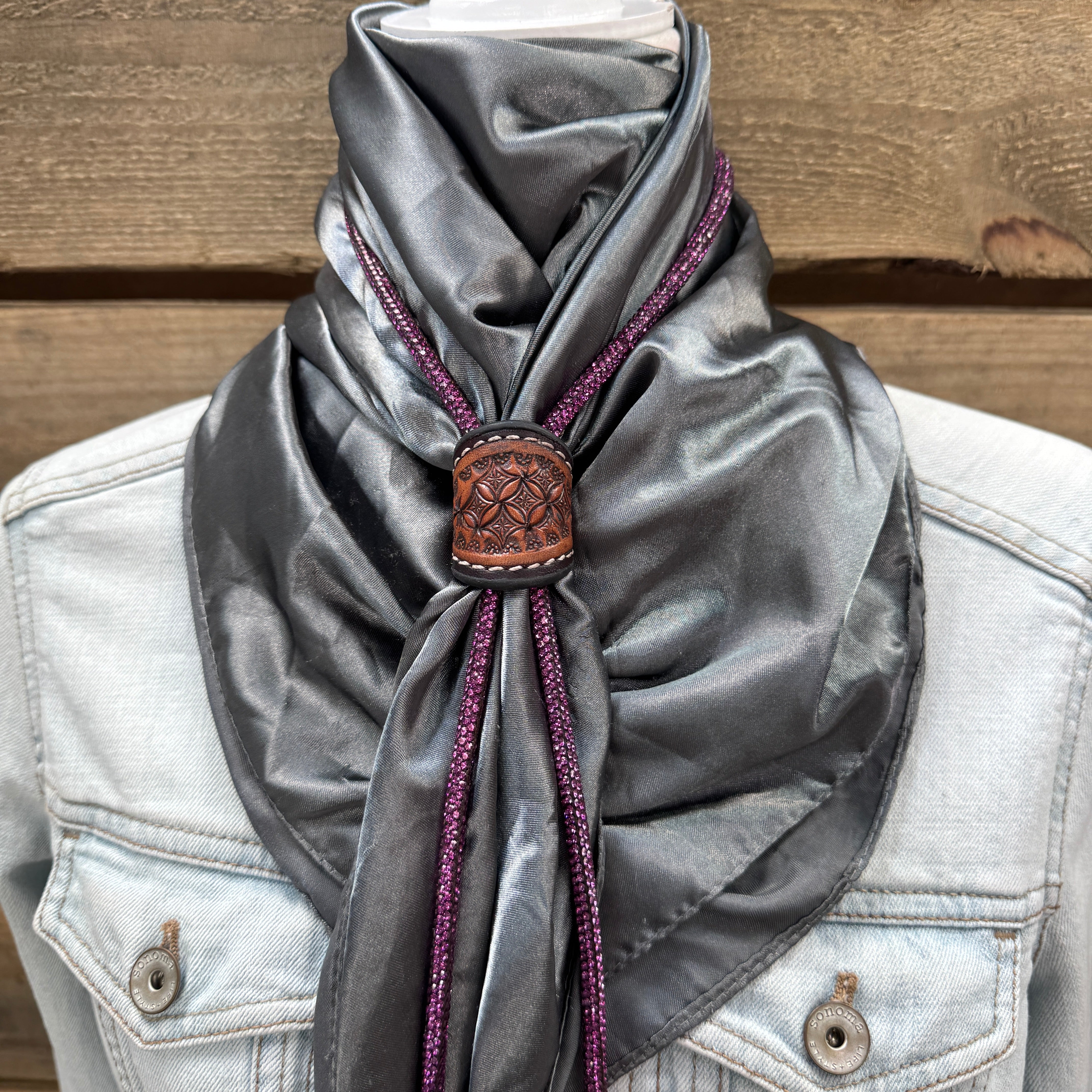 a scarf is tied to a jacket on a mannequin