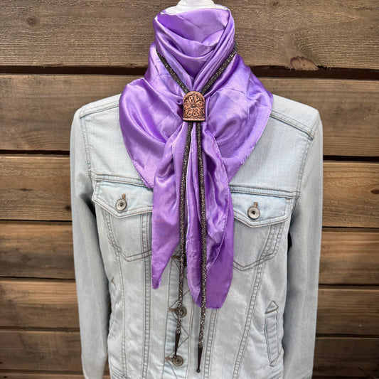 a purple scarf is hanging on a jacket
