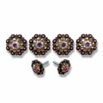 a collection of ornate, decorative buttons and knobs adorned with gemstones, including purple and gold accents.