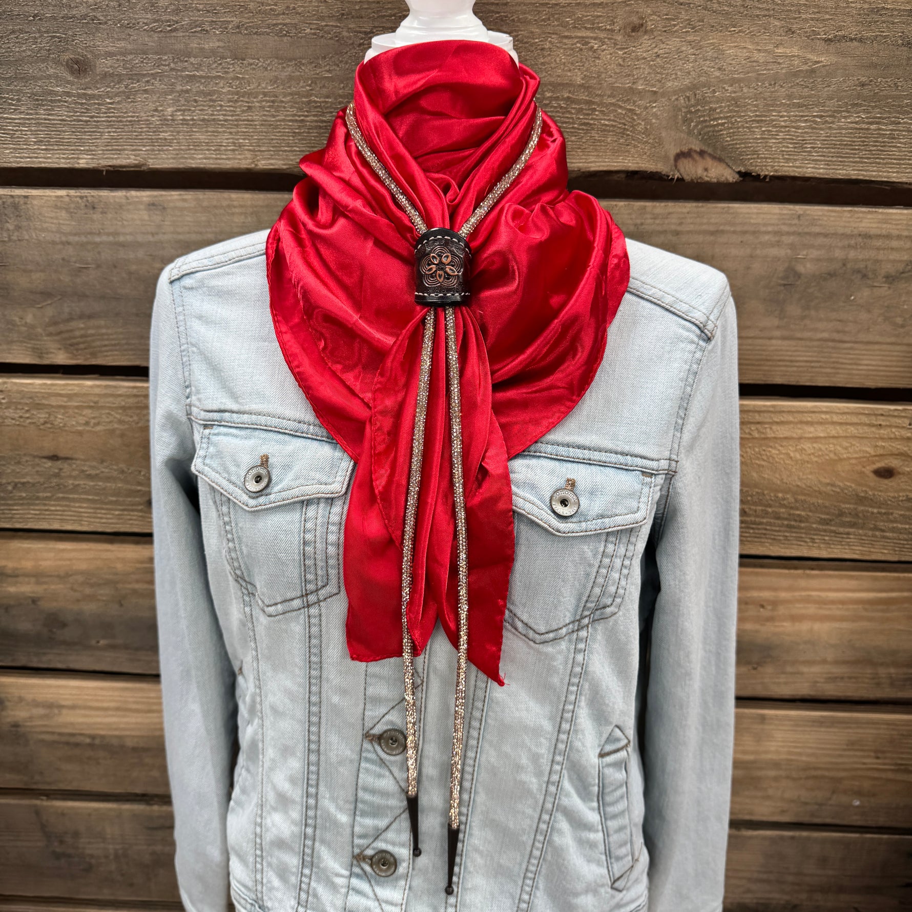a woman wearing a denim jacket and a red scarf
