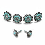a collection of ornate jewelry pieces, including earrings and buttons, adorned with turquoise stones and silver accents.