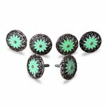 a collection of six decorative metal knobs with green and black floral designs. The knobs are arranged in two rows of three, with three knobs in each row.