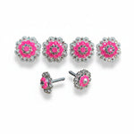 a collection of pink and silver decorative items, including earrings and buttons, arranged in a row.