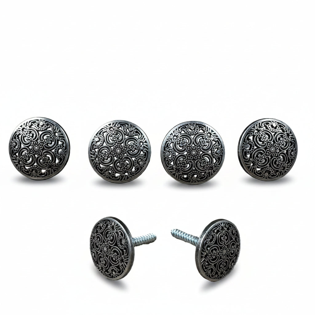 a collection of ornate, circular knobs or buttons with intricate designs, arranged in a row.