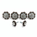 a pair of ornate, antique-style buttons adorned with rhinestones or crystals, arranged in a row.
