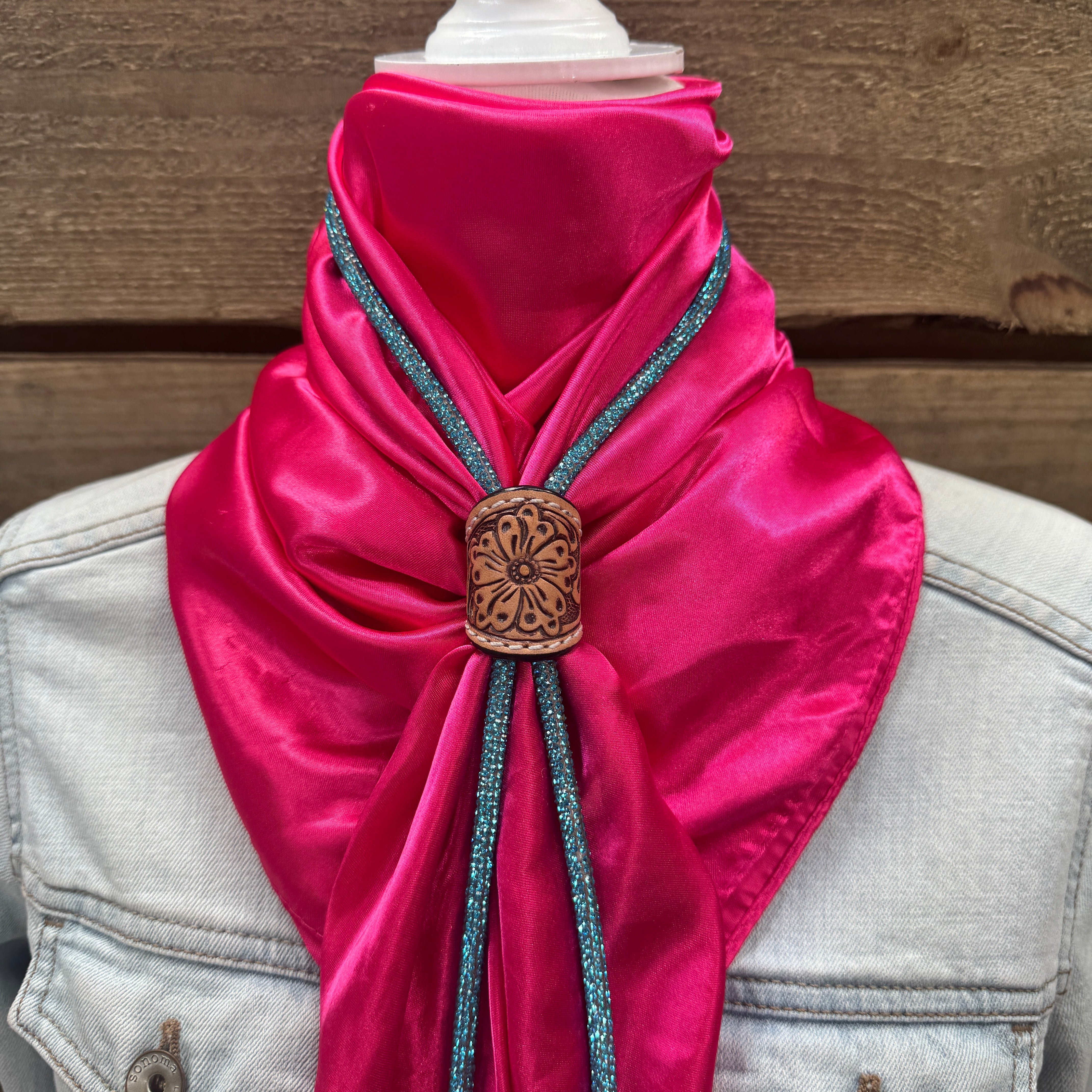 a pink scarf with a wooden button on it