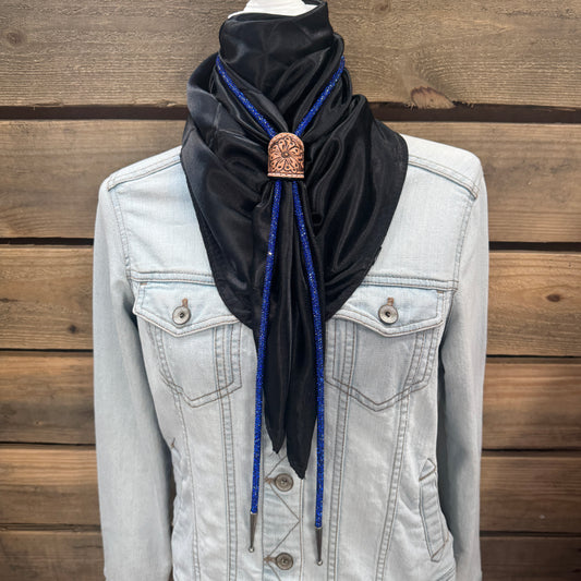 a woman wearing a black scarf and a denim jacket