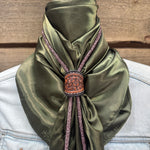 a close up of a person wearing a green scarf