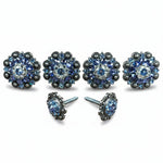 a collection of ornate, blue-colored jewelry pieces, including earrings and a necklace, with intricate designs and sparkling gemstones.