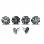 a collection of five round metal buttons with star-shaped designs, each adorned with blue accents. The buttons are arranged in a row, with two of them being identical.