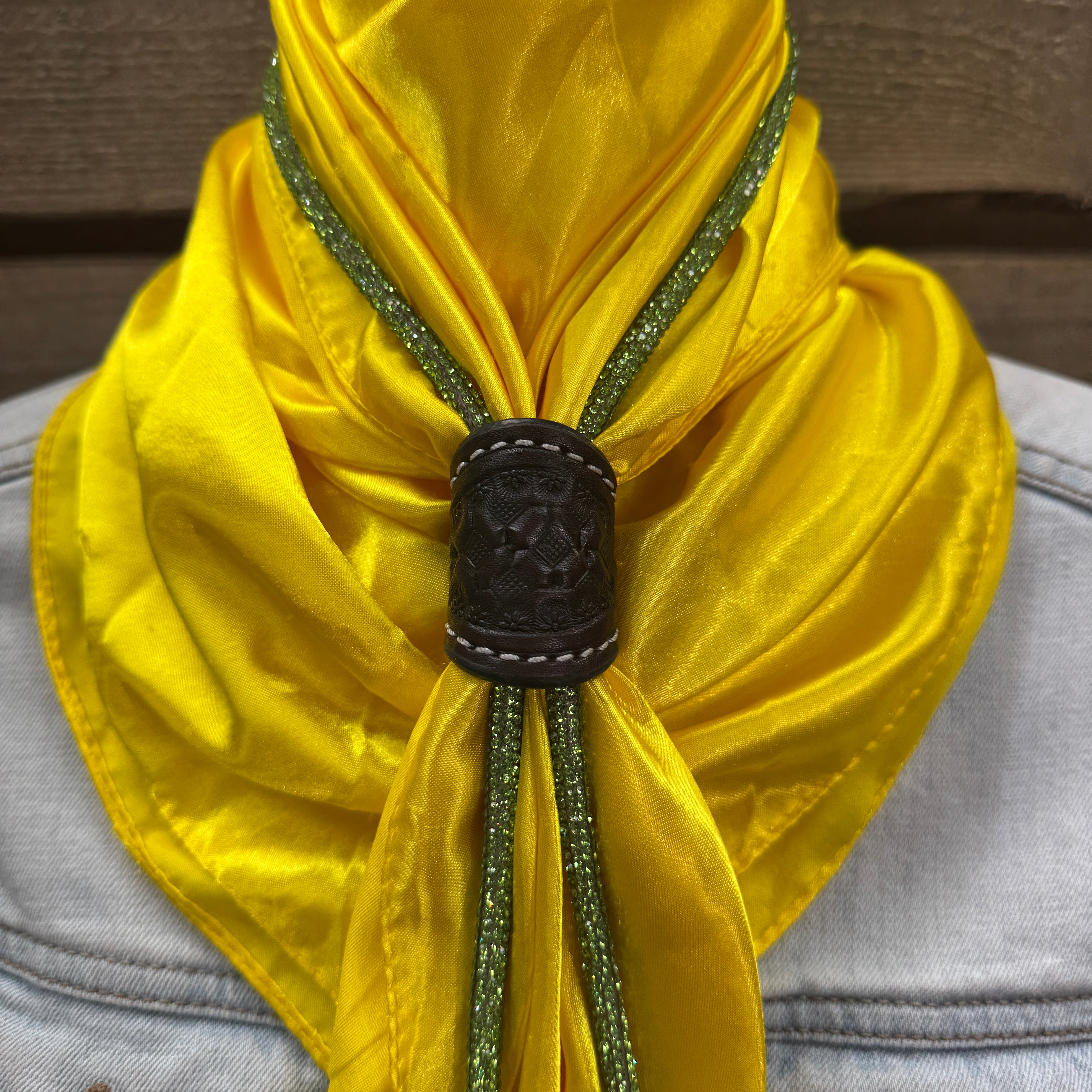 a close up of a yellow scarf on a mannequin