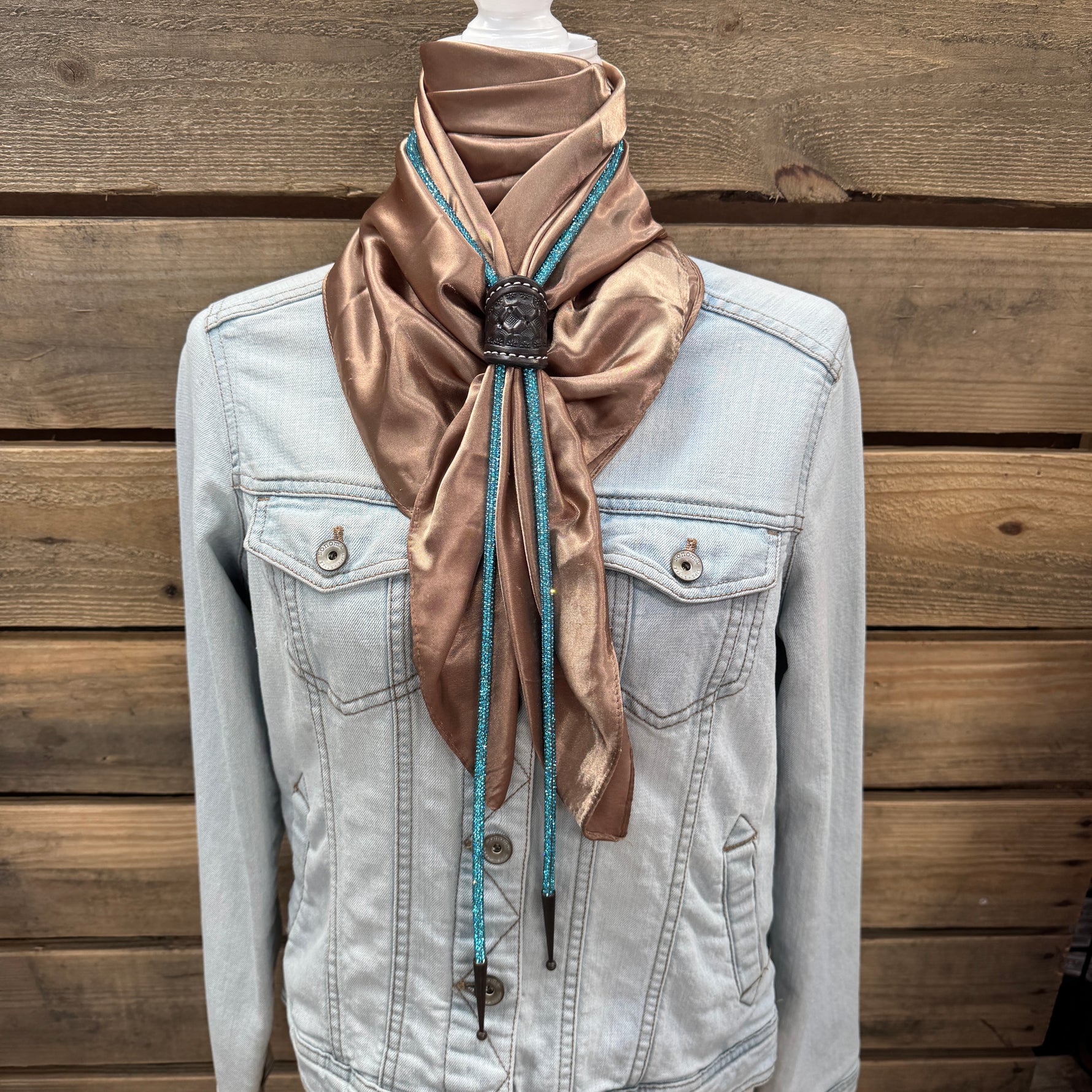 a white jacket with a brown scarf on top of it